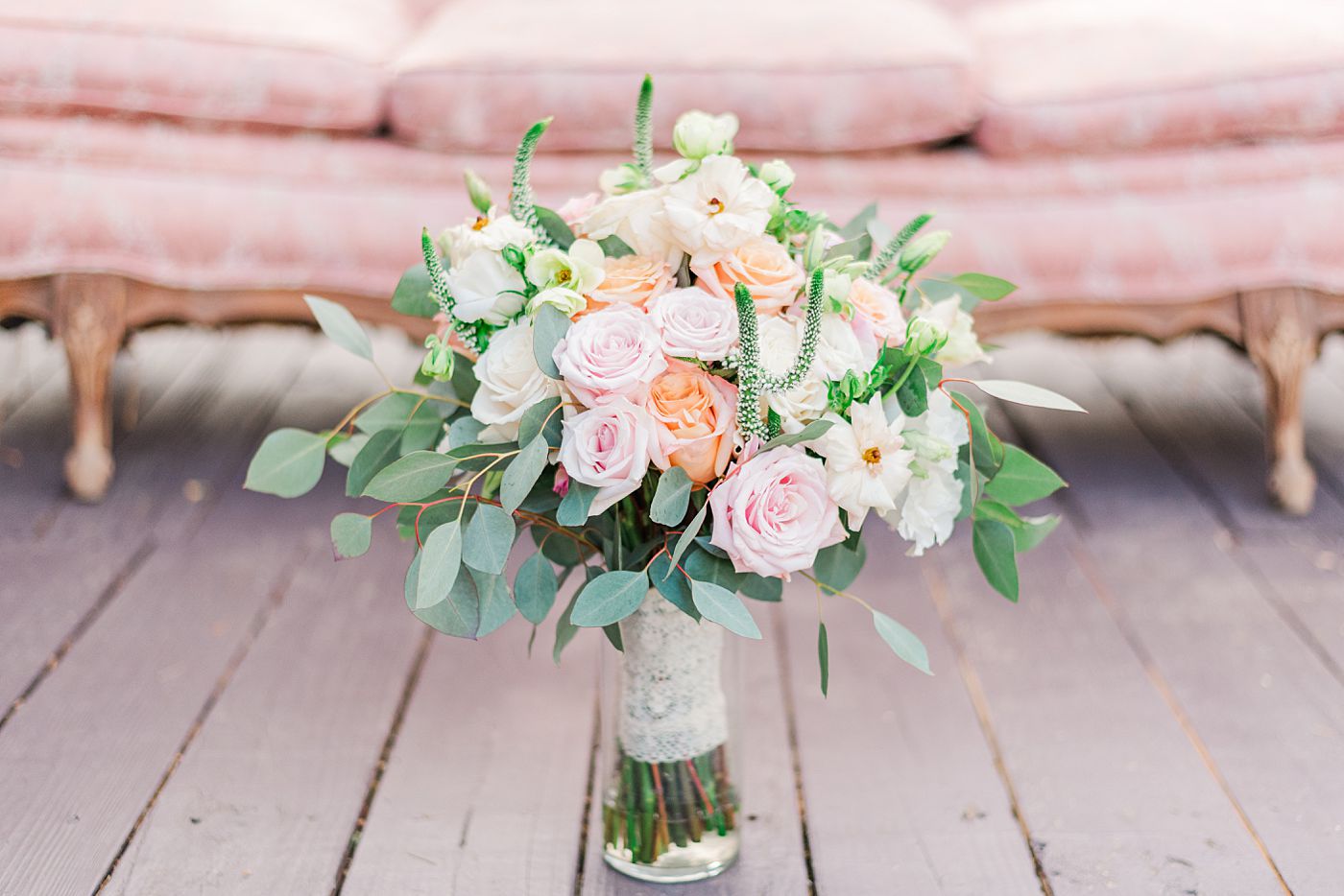 a bouquet of pink and white roses in a vase
