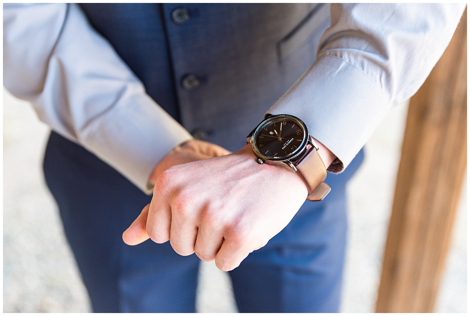 groom with watch on wedding day