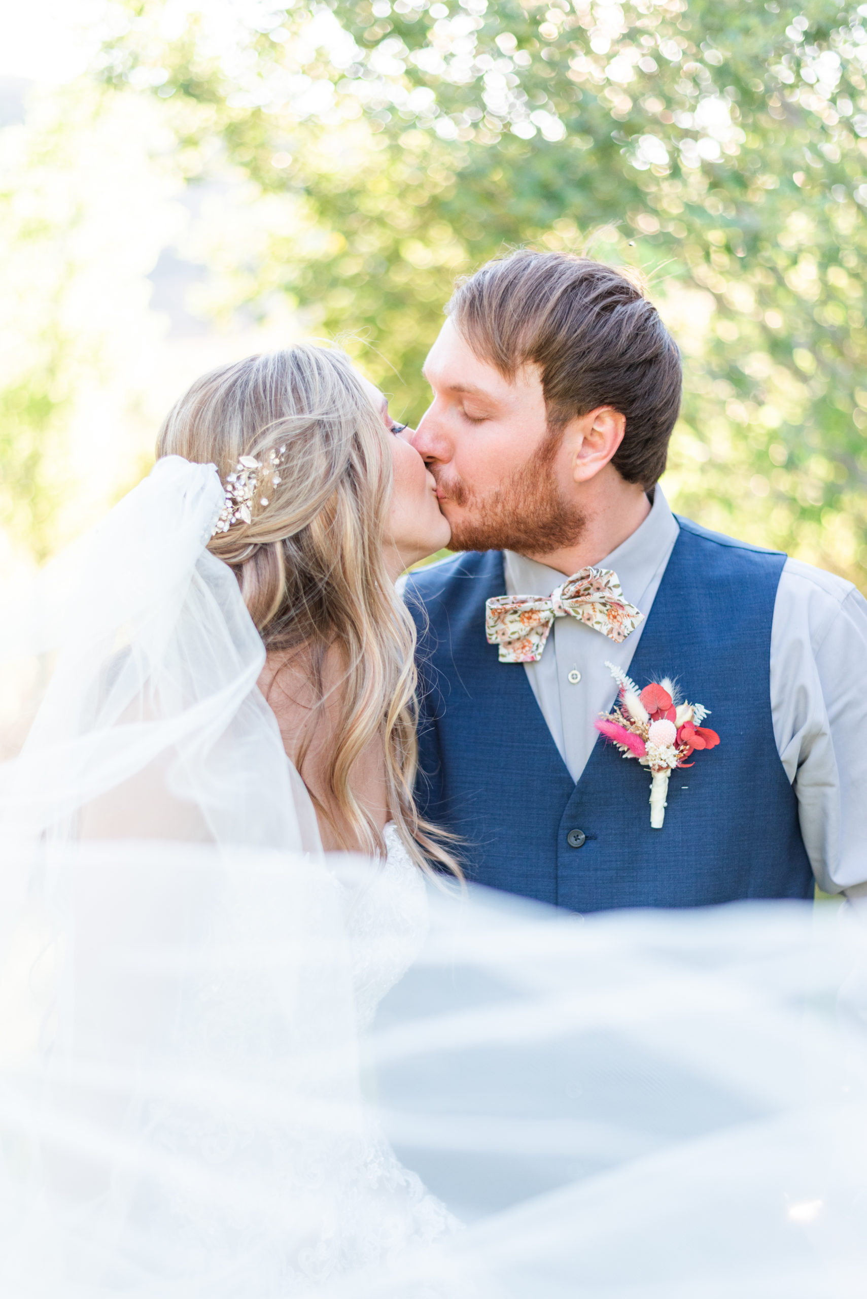 man and wife kissing on wedding day