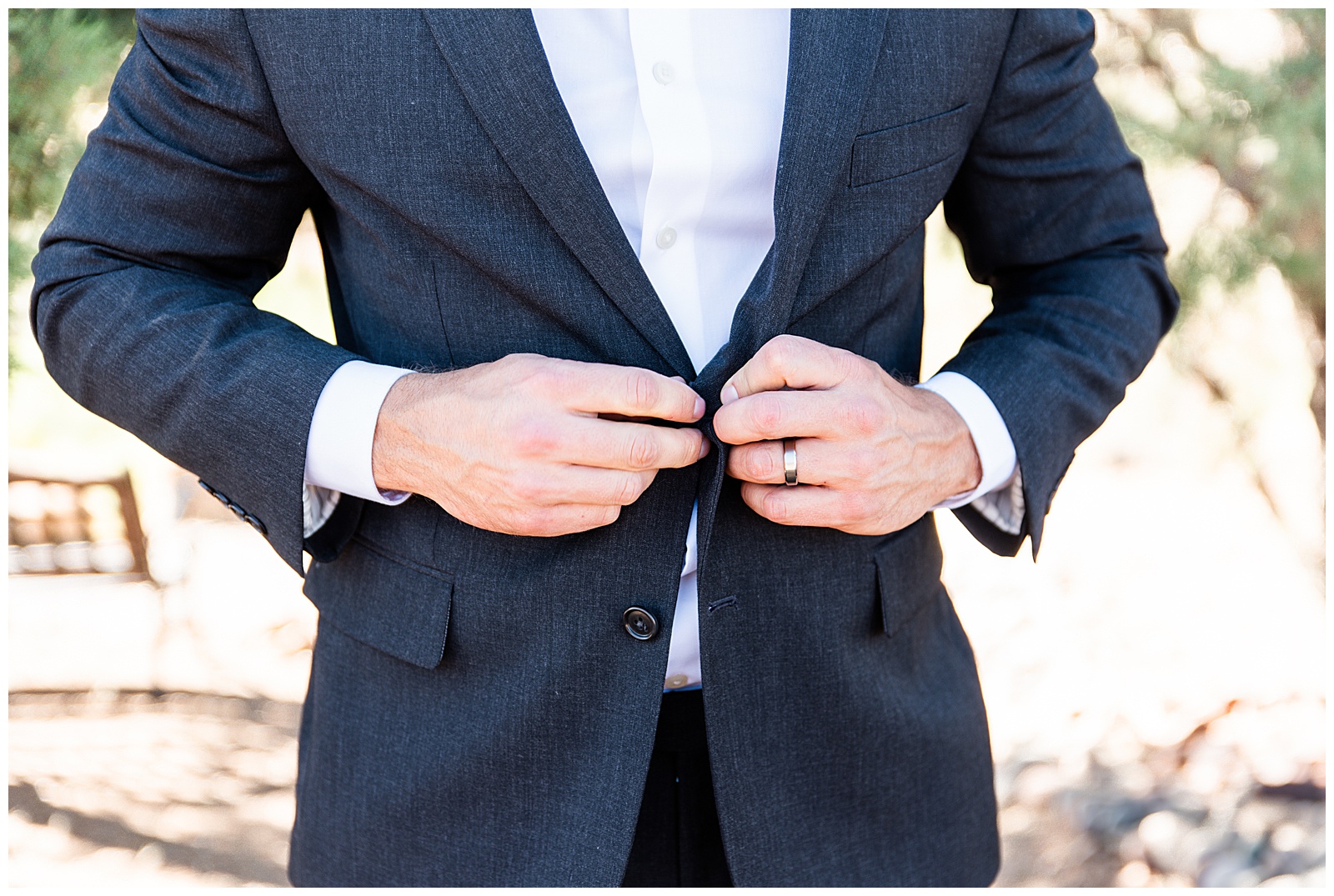 man buttoning his suit