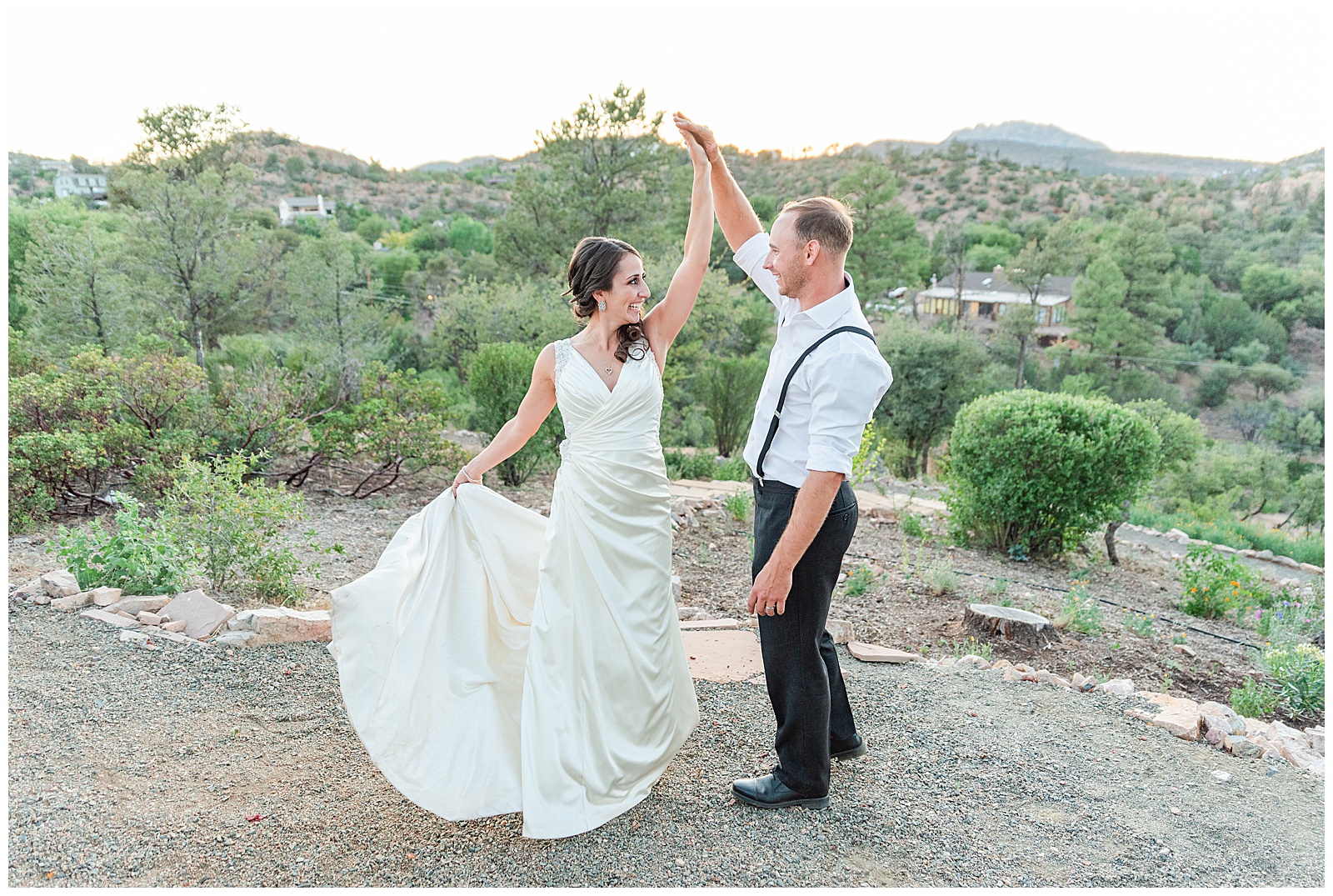 bride and groom dancing with mountain views behind them