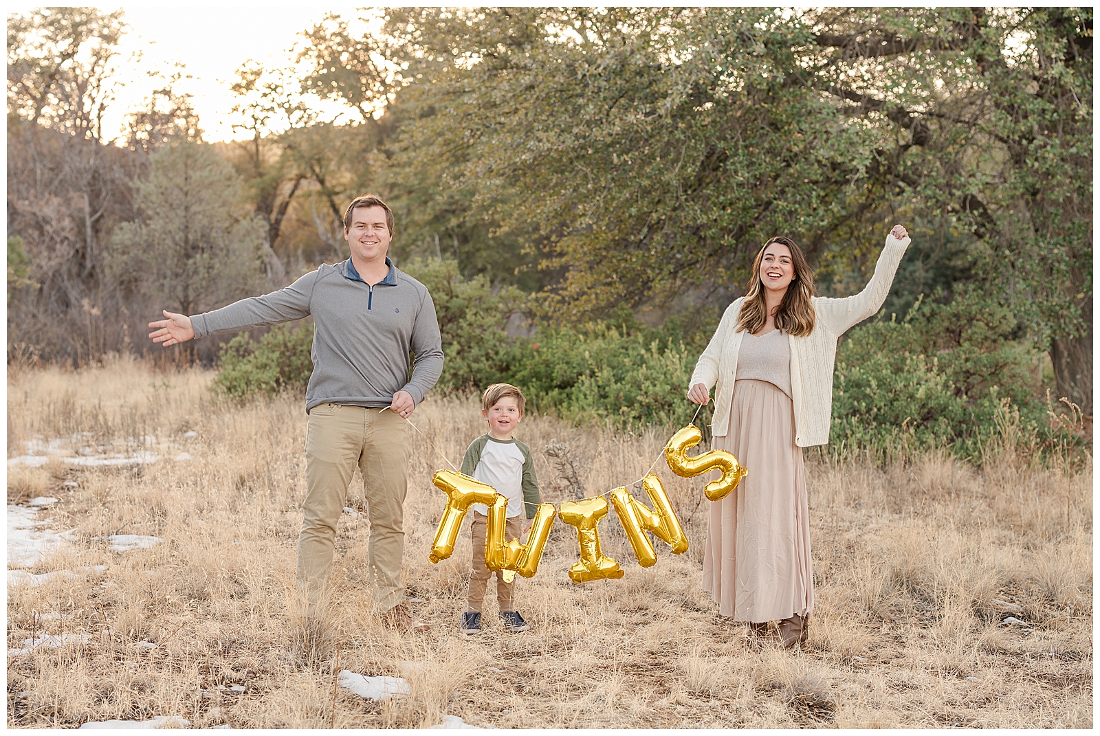 a man and woman with son holding gold balloon