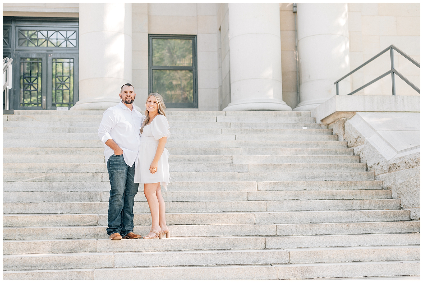 man and woman standing on steps wearing white
