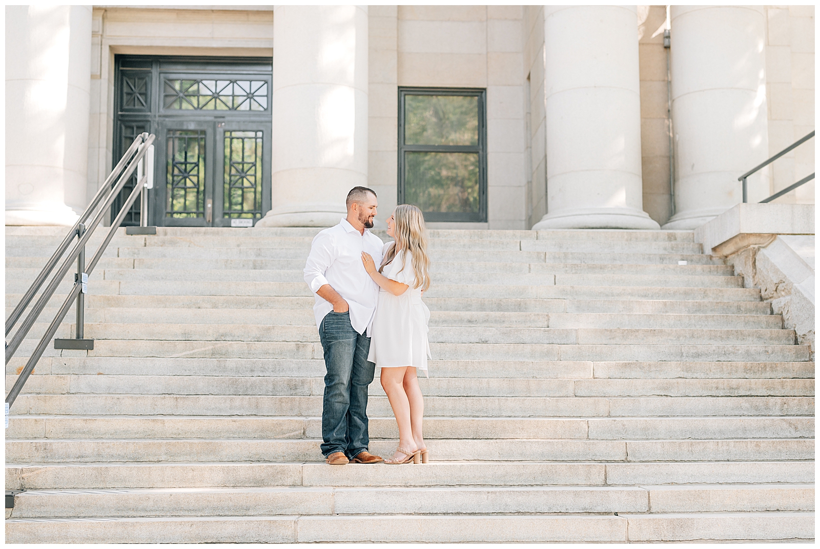 man and woman standing on steps wearing white
